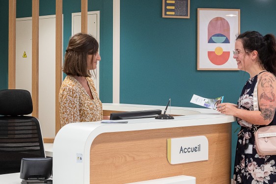 Patiente à l'accueil avec la brochure